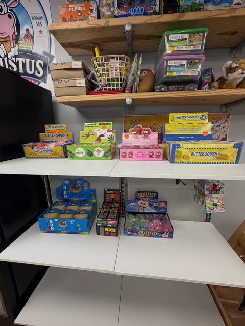 Shelves of sensory toys and fidget items for sale, including squishies and fidget boxes